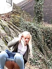15 pictures - Blonde in denims squats outside to relieve herself