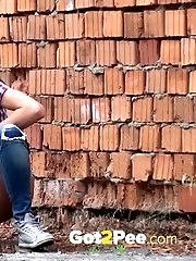 15 pictures - Sexy brunette pisses in an alleyway