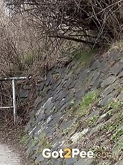 15 pictures - Black haired girl pisses on a public path