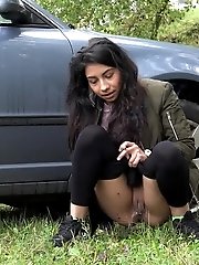 15 pictures - Exotic babe squats behind parked car to piss