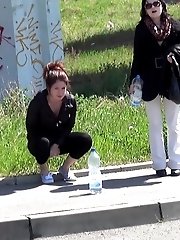 15 pictures - Pretty brunette pisses next to a parked van