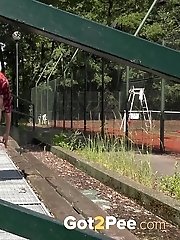 15 pictures - Pretty redhead is desperate to piss while outside
