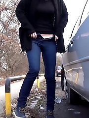 15 pictures - Brunette girl squats near a car to piss outside