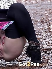 15 pictures - Playful babe nearly wets her panties outside