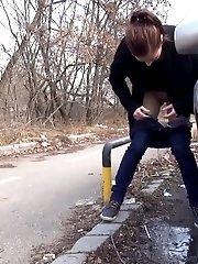 15 pictures - Brunette girl squats near a car to piss outside