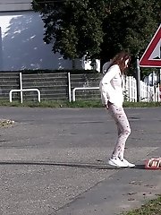 15 pictures - Brunette girl makes a pissy puddle on the road