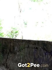 15 pictures - Dark haired babe pisses on the ground
