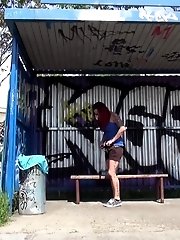 15 pictures - Cute redhead pisses onto a wooden bench