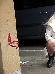 15 pictures - Sexy girl in glasses pisses in a car park space