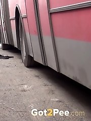 15 pictures - Sexy blonde girl pisses between parked buses