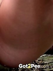 15 pictures - Blonde babe in blue pisses on the ground outside