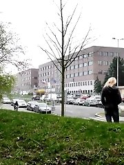 15 pictures - Pretty blonde pisses in public outside buildings