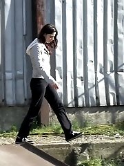 15 pictures - Gorgeous brunette filmed twice pissing outside