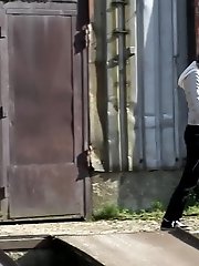 15 pictures - Gorgeous brunette filmed twice pissing outside