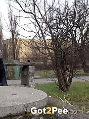 15 pictures - Pretty redhead is caught twice pissing in public