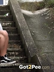 15 pictures - Cute girl in sneakers pisses on steps