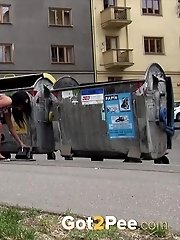 15 pictures - A shy girl needs to piss while outside in the city