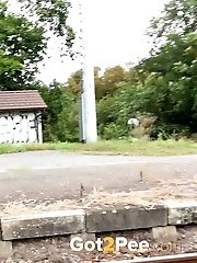 15 pictures - Sexy brunette pisses over the train tracks