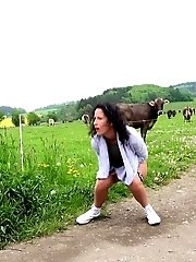 15 pictures - Dark haired girl pisses on the grass outside