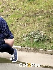 15 pictures - Redhead babe pulls down her denims to piss