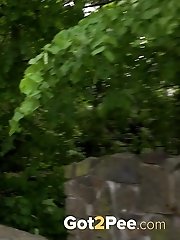 15 pictures - Brunette pulls down denims to piss outside