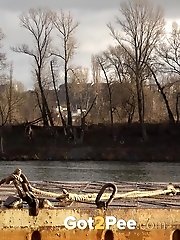 15 pictures - Pretty blonde squatting to pee by the river
