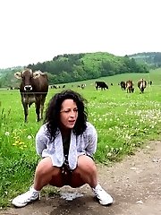 15 pictures - Dark haired girl pisses on the grass outside