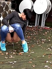 15 pictures - Gorgeous babe in sneakers squats to piss outside