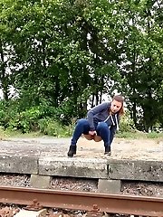 15 pictures - Sexy brunette pisses over the train tracks