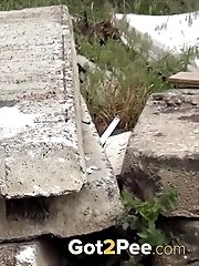 15 pictures - Hot blonde pisses onto a concrete slab
