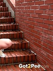 15 pictures - Pretty blonde squats on steps outside to piss