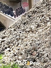 15 pictures - Gorgeous dark haired girl pisses near some stones