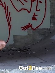 15 pictures - Sexy dark haired girl fires piss onto the concrete