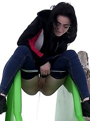 15 pictures - Public pissing for dark haired babe in the park