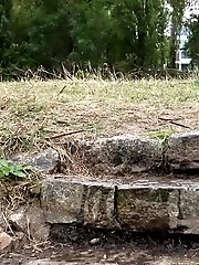 15 pictures - Brunette pisses outside on some steps