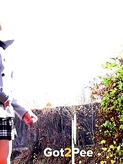 15 pictures - Blonde in check skirt pisses on the ground