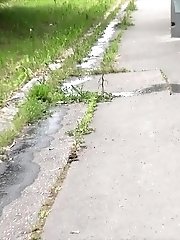 15 pictures - Pretty brunette pisses twice in this outdoor scene