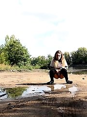 15 pictures - Brunette girl keeps a lookout while pissing