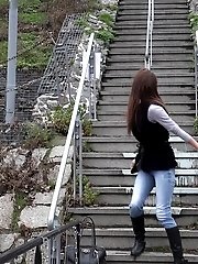 15 pictures - Sexy brunette babe pisses in public on some steps