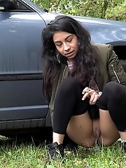 15 pictures - Exotic babe squats behind parked car to piss