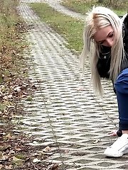 15 pictures - Blonde European pisses on a path on a trail