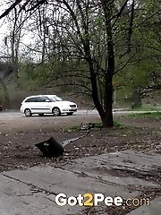 15 pictures - Blonde girl pisses in public as cars drive past