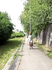 15 pictures - Pretty brunette pisses twice in this outdoor scene