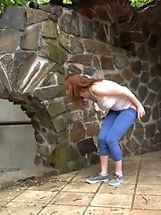 15 pictures - Brunette pulls down denims to piss outside