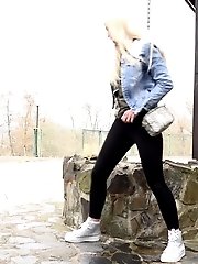 15 pictures - Blonde babe squats and pisses outside near a well