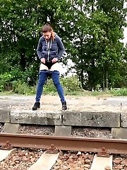 15 pictures - Sexy brunette pisses over the train tracks