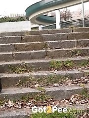 15 pictures - City pissing for cute short haired babe