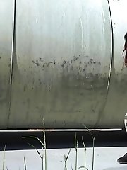 15 pictures - Busty brunette pissing on an industrial area