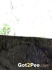 15 pictures - Dark haired babe pisses on the ground
