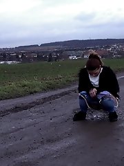 15 pictures - Dark haired babe in denims pees outside